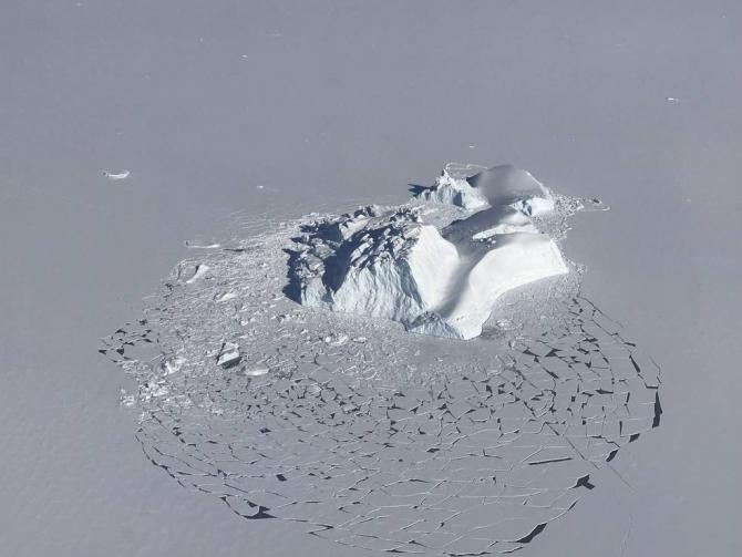A large iceberg floating among sea ice floes, as seen during an operation IceBridge survey flight on Apr. 21, 2018. Credits: NASA/Linette Boisvert