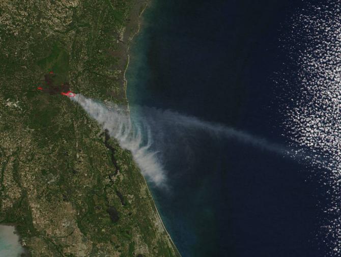 Brown carbon particles produced by wildfires such as the ones that have scorched parts of Georgia and Florida this year are more likely than previously thought to travel to the upper levels of the atmosphere and impact climate. Credits: NASA image courtesy Jeff Schmaltz LANCE/EOSDIS MODIS Rapid Response Team, GSFC