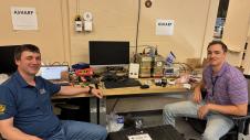 Dominik Cieslak and Ian Decker with the Airborne Version of Hyper-Angular Rainbow Polarimeter (AirHARP) system on the bench prior to ER-2 installation