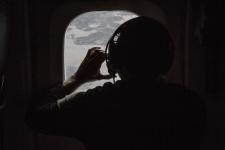 Researcher photographing the sea ice as the DC-8 flies over the Arctic January 2017. Credits: NASA / National Center for Atmospheric Research / Sam Hall