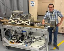 David Corredor and the Electric Field Change Meter (EFCM) mounted in a mezzanine rack ready for the ER-2