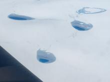 Supraglacial lakes freezing over along Greenland's northwest coast.