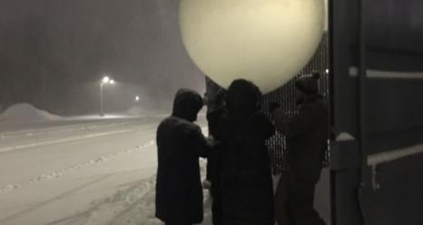 A group of Stony Brook students getting the weather balloons ready for a past storm on January 28, 2022. The instruments are tied to strings attached to the balloons, including a parachute and GPS system that provides the location of the balloon. Around 8 kilometers (5 miles), the communication drops off and contact is lost with the system. Photo Courtesy of Brian Colle.